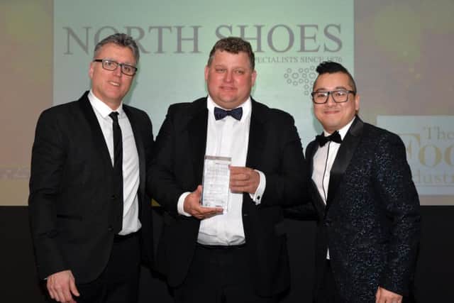 North Shoes managing director James North (centre) receives the independent family footwear retailer of the year 2018 award from Will Cheung (right), sales manager for Skechers UK and Ireland, the award sponsors. With them is host of the event, comedian Sean Collins.