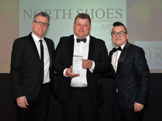 North Shoes managing director James North (centre) receives the independent family footwear retailer of the year 2018 award from Will Cheung (right), sales manager for Skechers UK and Ireland, the award sponsors. With them is host of the event, comedian Sean Collins.