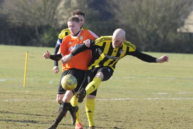 Action from Thorney's win over Holbeach United Reserves (stripes). Photo: David Lowndes.