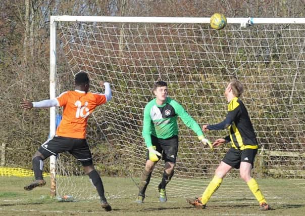 John Yambasu (orange) scores for Thorney against Holbeach United. Photo: David Lowndes.