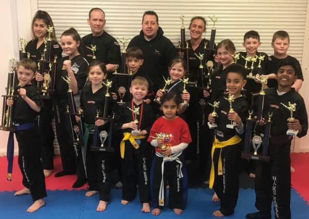 Pictured are some of the Hicks Karate School trophy winners at the Peterborough Championship. From the left are, back, Elise Ward, David Prior,  chief instructor Andrew Hicks, Sarah Ward, Aaron Leonard, Warren Bothamley. middle, Casey Stone, Denas Jankauskas, Sophie Hicks, Lucy Hicks, front, Oliver Profitt, Sophie Doyle,  Joshua Leonard, Tiana Celaire, Joell Celaire and Raihan Ebrahim.