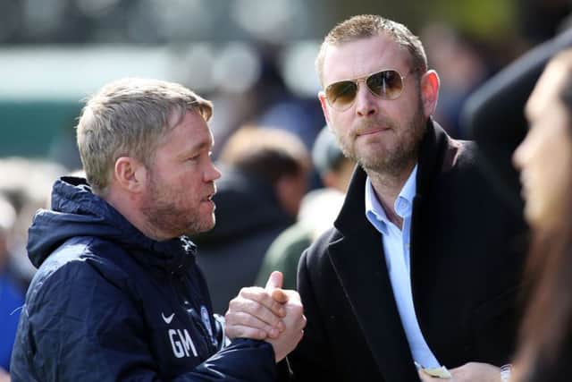 Posh chairman Darragh MacAnthony (right) with Grant McCann.