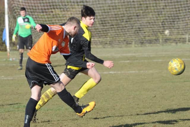 Action from Thorney (orange) v Holbeach United Reserves in the President's Shield semi-final. Photo: David Lowndes.