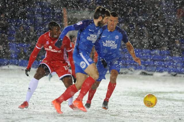 Michael Doughty on the ball for Posh against Walsall, watched by teammate Steven Taylor. Photo: David Lowndes.