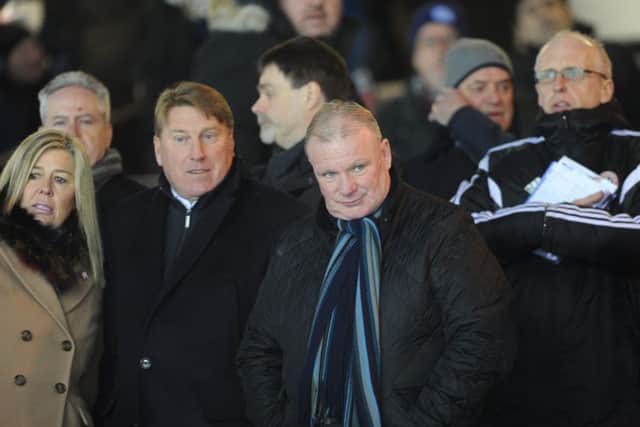 Future Posh manager Steve Evans (right) and assistant Paul Rayner watch the Walsall game from the ABAX Stadium director's box. Photo: David Lowndes.