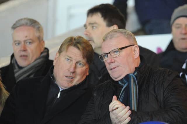 Prospective new Posh management team Steve Evans (right) and Paul Rayner watch the win over Walsall. Photo: David Lowndes.