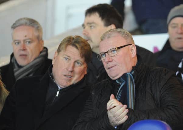 Prospective new Posh management team Steve Evans (right) and Paul Rayner watch the win over Walsall. Photo: David Lowndes.