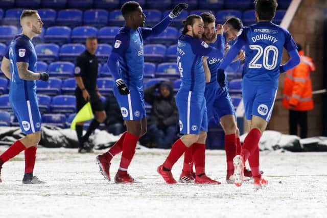Posh skipper Jack Baldwin is congratulated by teammates after his part in the winning goal against Walsall. Photo: Joe Dent/theposh.com.