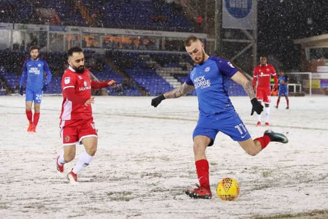 Posh forward Marcus Maddison and Walsall's Erhun Oztumer in action in the snow at the ABAX Stadium. Photo: Joe Dent/theposh.com