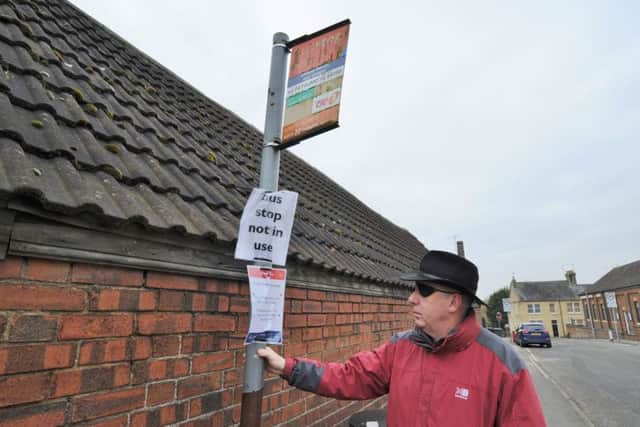 Coun. John Whitby at the unused bus stop at Chapel Street, Stanground EMN-180223-162912009