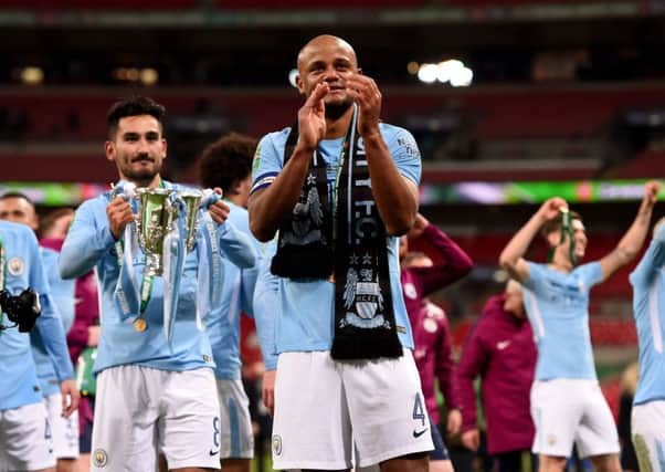 Vincent Kompany (centre) celebrates Manchester City's Carabao cup success.