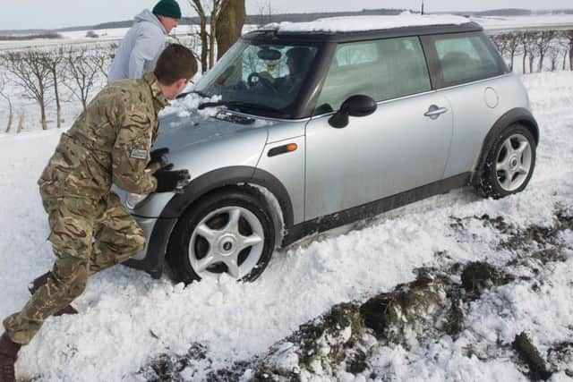 RAF Wittering personnel helping drivers battle through the snow