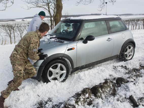 RAF Wittering personnel helping drivers battle through the snow