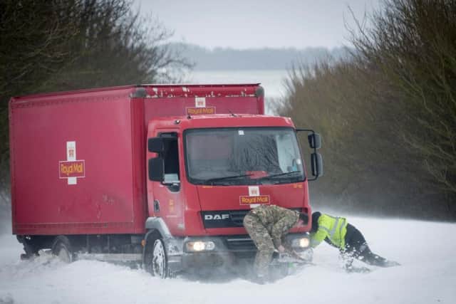 RAF Wittering personnel helping drivers battle through the snow