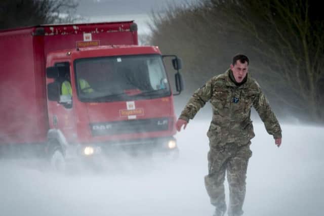 RAF Wittering personnel helping out motorists in the snow in Lincolnshire last week