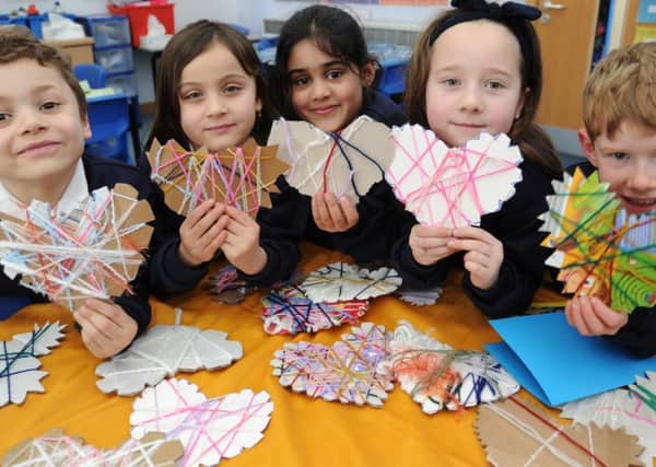 Art exhibition at Longthorpe primary school -  year 2 pupils with their artwork (no names given) EMN-180223-163102009