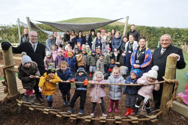 Councillors Dave King and Marco Cereste at the opening of the new garden play area at Cygnets pre-school at Hampton Hargate with children, staff and parents EMN-180226-160745009