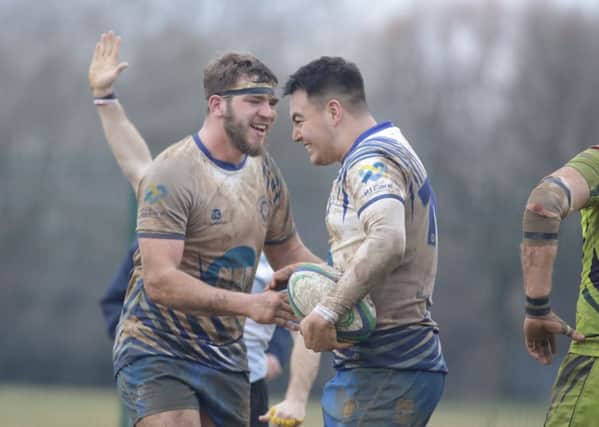 Kaz Henderson (right) is congratulated by team-mate Tom Lewis after scoring the winning try for the Lions. Picture: Mick Sutterby