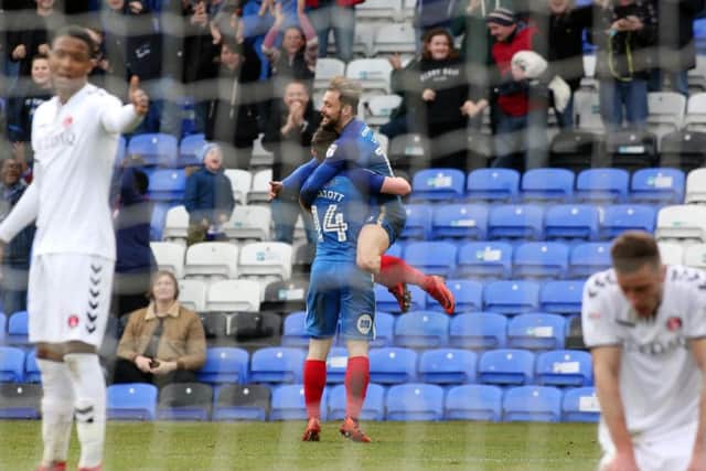 Posh substitute Danny Lloyd helps Jack Marriott celebrate his first goal against Charlton. Photo: Joe Dent/theposh.com.