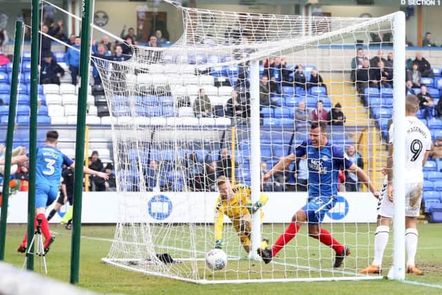 Andrew Hughes wheels away in celebration after opening the scoring for Posh against Charlton. Steven Taylor has followed the ball into the next. Photo: Joe Dent/theposh.com.