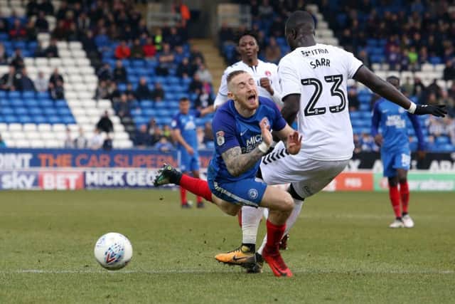 Posh star Marcus Maddison is fouled by Charlton's Naby Sarr in the penalty area. Photo: Joe Dent/theposh.com.