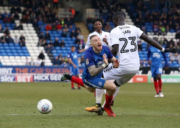 Posh star Marcus Maddison is fouled by Charlton's Naby Sarr in the penalty area. Photo: Joe Dent/theposh.com.