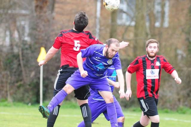 Action from Weldon United's county cup win at Peterborough NECI (purple). Photo: David Lowndes.