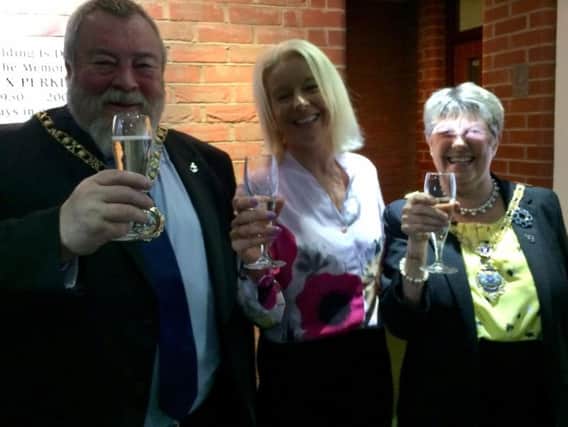 Toasting 10 years of Safe Local Trades  director Eileen Le Voi (centre) joined by Peterborough City Council Mayor Cllr John Fox and Mayoress Judy Fox.
