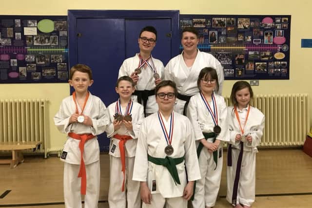 The successful Sensei Simone Karate Club members. From the left are  Marcus Wren, Alfred Bradbury,  Jacob Hardwick, Oliver Plumb (front), Simone Hodson, Aneesha Plumb and  Maycie Rose Ramsey.
