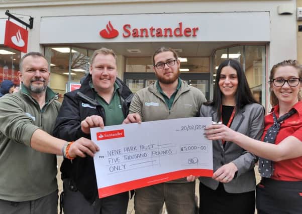 Paul Easthorpe, Gareth Lorman and Devon Brooks from Nene Park Trust receive cheque from Stella Gatehouse (branch director) and Holly Simpson (customer services) at Santander, Long Causeway EMN-180221-155038009