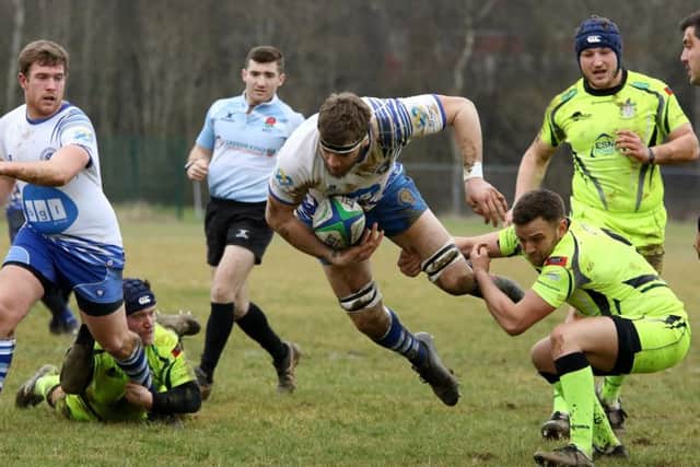 Lions second row forward Tom Lewis is sent flying by a Scunthorpe player. Picture: Mick Sutterby