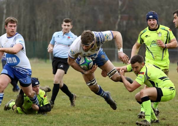 Lions second row forward Tom Lewis is sent flying by a Scunthorpe player. Picture: Mick Sutterby