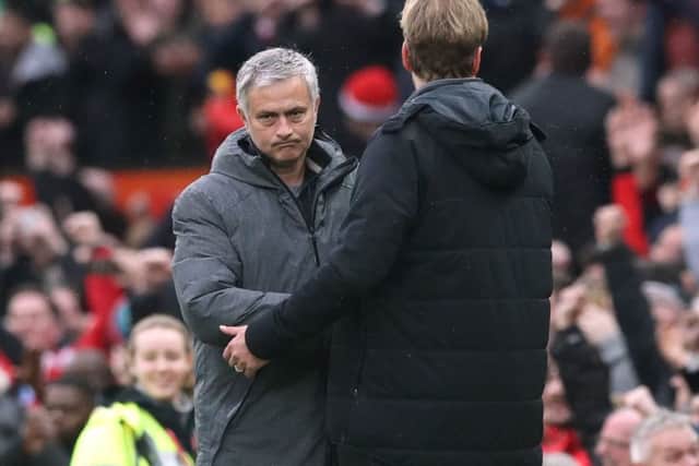 Rival managers Jose Mourinho (left) and Jurgen Klopp shake hands at Old Trafford.