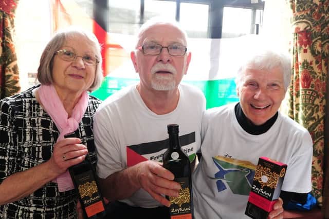 Peterborough Women's Festival at the Town Hall.  Anne Green, Patrick Brooks and Jennie Mead running the Palestine Solidarity Campaign stand EMN-181003-174018009