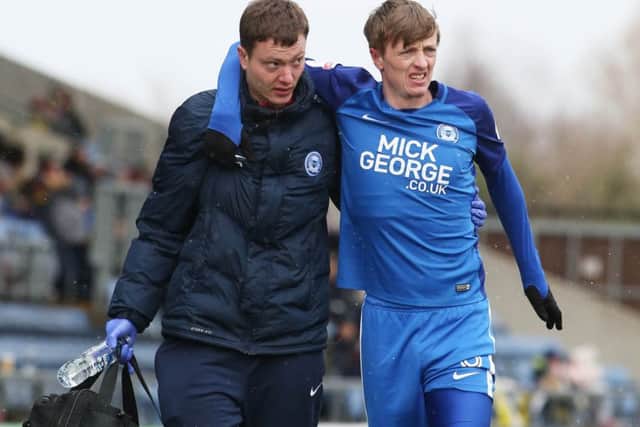 Posh misfielder Chris Forrester limps out of the game against Oxford after getting a nasty cut just above his knee. Photo: Joe Dent/theposh.com.