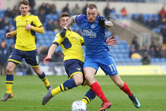 Posh star Marcus Maddison takes on Oxford's Cameron Brannagan. Photo: Joe Dent/theposh.com.