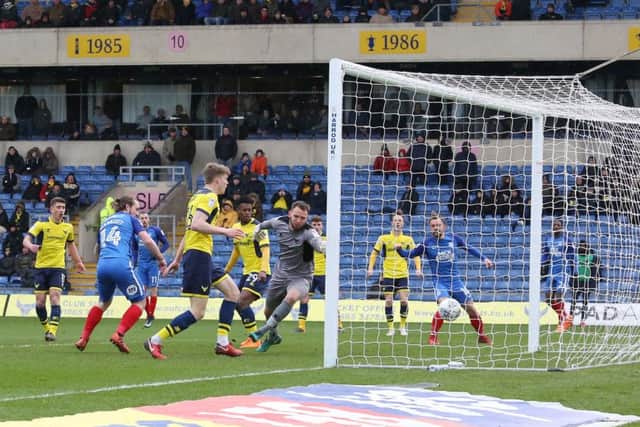 Jack Marriott (blue, left) scores the Posh goal at Oxford. Photo: Joe Dent/theposh.com.