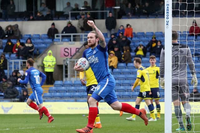 Posh striker Jack Marriott salutes the visiting fans after his goal at Oxford. Photo: Joe Dent/theposh.com.