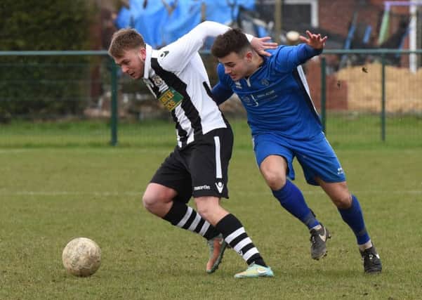 Jake Sansby (stripes) in action for Peterborough Northern Star against Cogenhoe. Photo: Chantelle McDonald. @cmcdphotos
