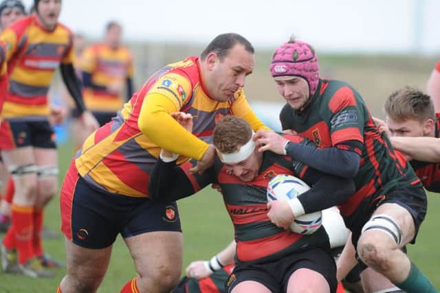 Borough captain Stuart Day (left) battles for the ball against Paviors.