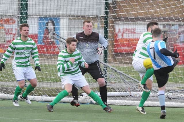 Action from the abandoned Intermediate Shield semi-final between Eye United and Premiair (blue). Photo: David Lowndes.