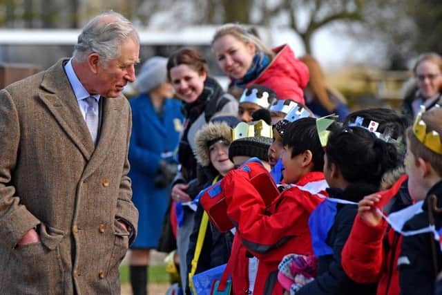Prince Charles chats to pupils from Highlees Primary School, Peterborough who greeted him on his visit to Tattershall Castle in Lincolnshire. Picture: John Aron.