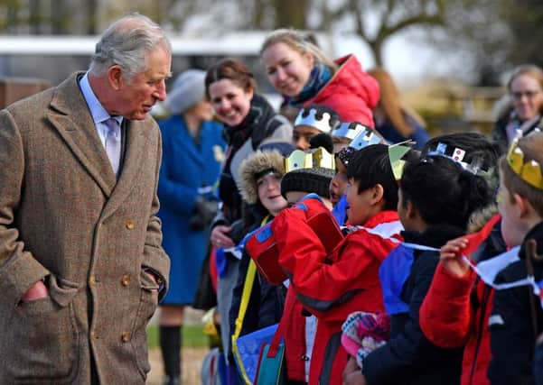 Prince Charles chats to pupils from Highlees Primary School, Peterborough who greeted him on his visit to Tattershall Castle in Lincolnshire. Picture: John Aron.