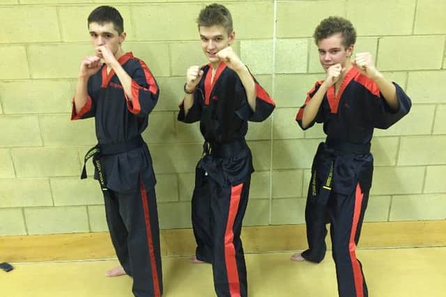 From the left are 2nd Dan black belts Stephen Alcock, Alexander Alcock and Alexander Ferguson.