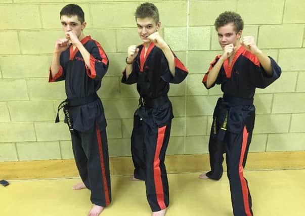 From the left are 2nd  Dan black belts  Stephen Alcock, Alexander Alcock  and Alexander Ferguson.
