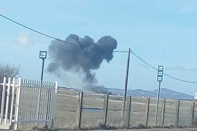 A plume of smoke rises from the crashed jet (Sian Rebecca Williams/PA)
