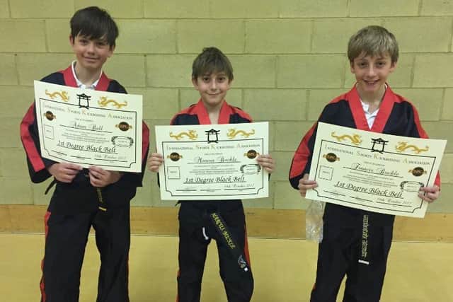 From the left are 1st Dan black belts Adam Bell, Marcus Buckle and Francis Buckle.