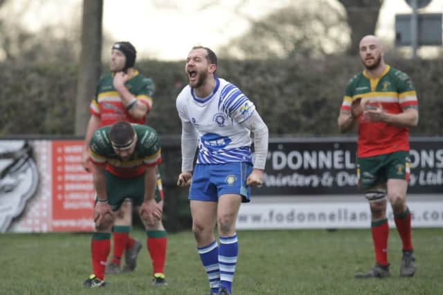 Lions scrum-half Tom Dougherty roars with delight on the final whistle at Sandbach. Picture: Mick Sutterby