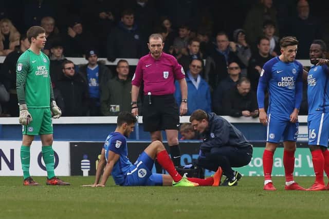 Central defender Ryan Tafazolli receives treatment on the early injury that forced him out of the Bristol Rovers game. Photo: Joe Dent/theposh.com.