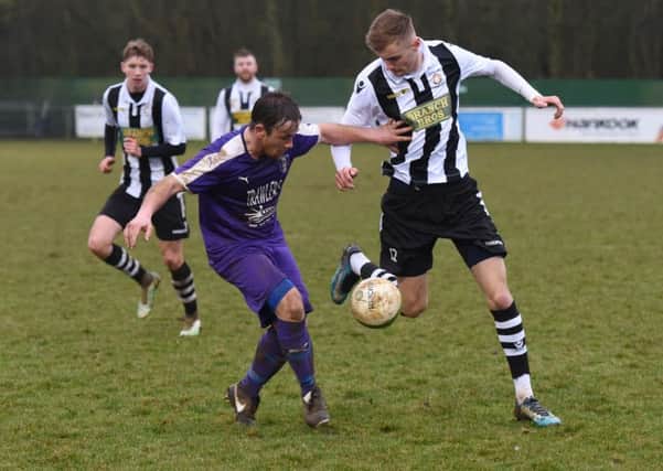 Tom Curtis (stripes) of Peterborough Northern Star in action at Daventry Town. Photo: Chantelle McDonald. @Cmcdphotos.